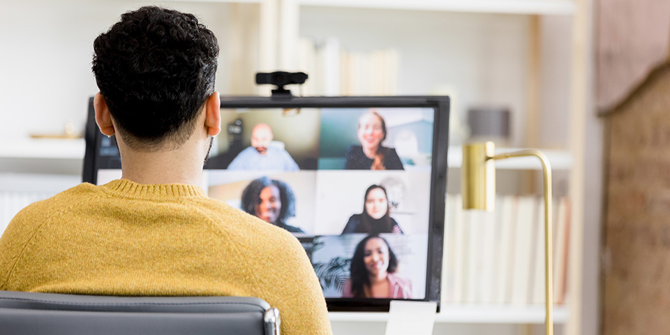 man watching a video seminar on his computer